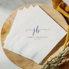 three personalized napkins sitting on top of a wooden table