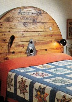 a bed with a wooden headboard and quilt on it