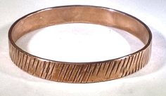 "Textured copper bangle Bangle is 8\"  in inside circumference, 2 1/2\" in diameter, 3/8\" wide, and 0.07\" thick. TO DETERMINE A BANGLE BRACELET SIZE STEP 1: Close your fingers together, bringing your thumb and little finger together (as though putting on a bangle). STEP 2: Using a strip of paper or tape measure, measure around the closed hand at the widest point, pulling the tape snug against the skin. If you are using a plain strip of paper, mark the paper with a pen, then measure the strip w Rose Gold Copper Cuff Bangle, Rose Gold Copper Bangle Cuff Bracelet, Unique Rose Gold Bangle Bracelet, Hammered Copper Bangle Bracelet, Hammered Copper Bangle Bracelets, Hand Forged Copper Bangle Bracelet, Handmade Copper Bangle Bracelets, Rose Gold Copper Bangle, Gold Round Copper Bangle