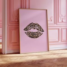 a pink room with a leopard print on the wall and a framed photograph of a woman's lips