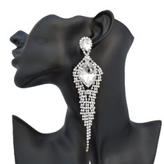 Style: Marquise pointed teardrop pave accented rhinestone statement earrings Color: Diamante rhinestones on silver Length: 5.25″ Post W/Pushback Closure Silver Crystal Bridal Earrings For Glamorous Events, Silver Earrings With Rhinestones For Glamorous Events, Crystal Chandelier Earrings With Rhinestone Fringe, Silver Rhinestone Earrings For Glamorous Events, Diamond White Crystal Earrings With Bling For Party, Glamorous Crystal Chandelier Earrings With Rhinestones, Glamorous Chandelier Earrings With Rhinestones, Glamorous Rhinestone Dangle Chandelier Earrings, Dangle Crystal Earrings With Rhinestone Fringe