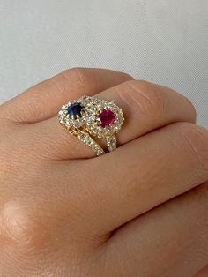 Antique 18k yellow gold ring featuring 36 old cut diamonds surrounding a crossover of sapphire and ruby central stones. Great antique condition Size: 6.25 resizable* Weight: 4.6 grams Band: 16.0 mm (front), 3.3 mm (back) Ruby: 5.0 mm x oval cut Sapphire: 5.0 mm x oval cut Diamonds: 2.0 mm x 36 old round cuts Aquamarine Stone Ring, Antique Ruby Ring, Ruby Wedding Rings, Sapphire Wedding Rings, Ring Ideas, Ruby Sapphire, Ruby Jewelry, Aquamarine Stone, 18k Yellow Gold Ring