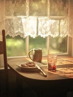 a wooden table with a plate of food on it next to a cup and saucer