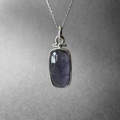 Stunning Large Size Violet Blue Iolite Necklace - Blue Iolite Pendant - Viking Compass Stone - Completely Handmade & Sterling Silver Gemstone: Natural Blue Iolite Metal: 925 Sterling Silver Stone Cuts: Cabochon Stone Size: 19.2 x 11.3 mm - 0.75 in x 0.44 in Pendant Size: 32.7 mm x 12.2 mm - 1.28 in x 0.48 in Weight: 5.96 grams (29.80 carats) total weight of stone and silver.  For ring orders, ring resizing is free.  Chains are gifts for necklace orders. Note: We don't use any filters for photos. The details may not be clear. Feel free to contact us with any questions, special orders or additional photo or video requests. We will be happy to provide more information! :) WORLDWIDE FedEx, UPS or TNT EXPRESS MAIL SERVICE (Delivery time: 1 - 5 business days.) LAYAWAY PAYMENT PLAN is available. Sapphire Gemstone Jewelry With Rectangular Pendant, Silver Faceted Tanzanite Jewelry, Sapphire Tanzanite Gemstones As Gift, Faceted Blue Amethyst Jewelry, Blue Faceted Amethyst Jewelry, Blue Amethyst Birthstone Jewelry, Blue Amethyst Pendant Jewelry, Silver Fluorite Gemstone Jewelry, Blue Oval Amethyst Jewelry