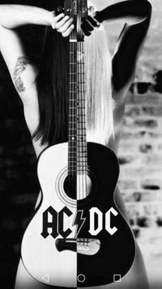 a woman with long hair holding a guitar in front of her face and the words ac / dc on it