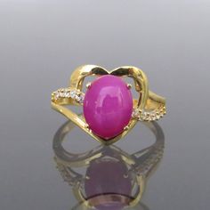 Vintage 18K Solid Yellow Gold Star Ruby & White Topaz Heart Ring ....Marked 18K...Total of weights 3.1grams...Size 7.5...With 01 Oval Star Ruby 10 x 8MM ( 2.54ct ) And 12 Round cut White Topaz's 1.3MM ( .01ct x 12 = .12ct ) Measure of Face 13.3MM...It's in very good condition. Heart-shaped Yellow Gold Jewelry With Center Stone, Heart Shaped Yellow Gold Jewelry With Center Stone, Gold Heart Ring With Gemstone For Valentine's Day, Gold Heart Ring With Oval Gemstone, Gold Ruby Ring With Gemstone For Valentine's Day, Gold Heart Ring With Gemstone, Gold Heart Jewelry With Gemstone Accents, Gold Heart Ring With Accent Stones Fine Jewelry, Yellow Gold Oval Heart Ring With Gemstone