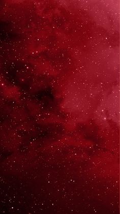 the sky is filled with stars and red hued clouds, as if it were in outer space