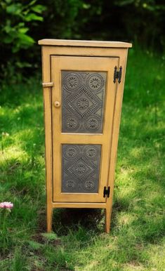 an old wooden cabinet sitting in the grass