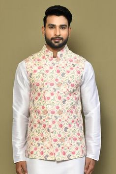 Yellow sleeveless bundi with botanical print and stitchline thread embroidery Paired with white full sleeve kurta and pant. - Aza Fashions Spring Wedding Nehru Jacket With Printed Motifs, Traditional Floral Print Bandhgala For Spring, Traditional Fitted Nehru Jacket With Floral Print, Traditional Spring Bandhgala With Floral Print, Traditional Fitted Floral Print Nehru Jacket, Fitted Traditional Nehru Jacket With Floral Print, Transitional Printed Nehru Jacket, Transitional Season Printed Nehru Jacket, Transitional Fitted Nehru Jacket With Printed Motifs