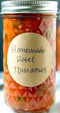 a jar filled with pickled tomatoes sitting on top of a table