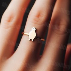 *Free engravings up to 20 characters* Waddle into a world of adorable charm with this minimalist penguin ring! 🌟 It's a perfect adornment for your finger or an ideal gift for anyone enchanted by the quirky and endearing nature of penguins. 🐧💕 This ring, great for stacking or as a solo piece, captures the delightful and unique character of penguins. Expertly crafted, it features a minimalist penguin design along a delicate band, bringing a touch of polar wonder to your style. Whether you're a fan of these charming birds or seeking a distinctive piece of jewelry, this penguin ring is a whimsical choice, ready to accompany you on every wintry adventure. ️ band width: 1.5mm Feel free to message us for customization! We can usually make minor alterations at no added charge. Covered by full w Penguin Ring, Penguin Design, Lover Jewelry, Gift Jewelry, Yellow Gold Rings, Enchanted, Penguins, Statement Rings, Ideal Gift