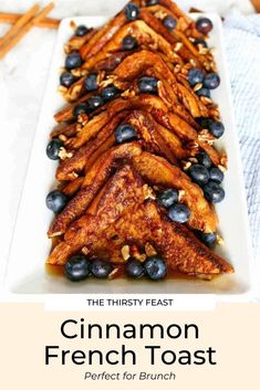 cinnamon french toast with blueberries and almonds on a white plate