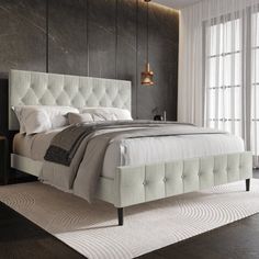 a bedroom with a large bed and white linens on the headboard is shown