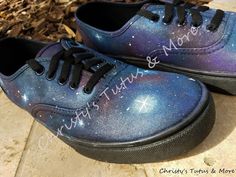 a pair of blue and purple shoes with stars painted on them