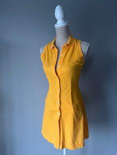 Vintage button up tank dress by Tom Tailor. * Vintage 90's * Great condition, like new! Brand * Tom Tailor Features * Material: Cotton * Button up and collar * Bright yellow Size in label * Fits S Please keep in mind that the listed items are Vintage and show signs of wear. If there is a notable sign of wear and/or missing part, damage etc. It will be noted in the product description. Fitted Button-up Summer Shirt Dress, Casual Summer Polo Dress For Daywear, Collared Cotton Polo Dress For Summer, Summer Cotton Collared Polo Dress, Summer Cotton Polo Dress, Fitted Sleeveless Cotton Shirt Dress, Retro Collared Mini Dress For Summer, Casual Summer Polo Dress, Vintage Button-up Mini Dress