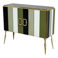 a green and white striped cabinet with gold accents on the front, two doors and three legs