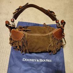 Never Used Dooney & Bourke Brown Suede Fringe Satchel. Features One Leather Adjustable Strap And Gold Hardware. Inside Of The Purse Is Red With A Zipper Pocket And Inside Pocket. Comes With Original Dust Bag. Bag Is Approximately 10 Inches High And 17-18 Inches Wide. Bigger Pockets, Fringe Handbags, Archive Fashion, Fringe Bags, Suede Fringe, Dooney & Bourke Bags, Country Girl, Bag Bag, Brown Suede