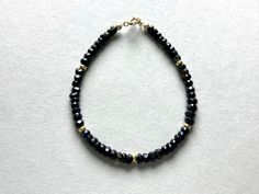 BLACK TOURMALINE GEMSTONE BRACELET WITH GOLD FILLED BEADS This pretty bracelet, made from black Tourmaline Beads has a length of 17.5cm.  If you need another length please let me know. Black Tourmaline stands for strong "earthing" Energy. I send all my jewelry packaged in a small cotton jewelry pouch. MATERIAL Black Tourmaline beads 4mm Clasp and beads Gold filled length 17,5cm Black Adjustable Rondelle Beaded Bracelets, Black Crystal Bracelet With Spacer Beads For Gift, Gift Black Crystal Bracelet With Spacer Beads, Black Rondelle Jewelry As A Gift, Black Bracelets With Spacer Beads As Gift, Black Bracelets With Spacer Beads For Gift, Minimalist Black Beaded Bracelets With Faceted Beads, Faceted Black Crystal Bracelet Gift, Black Beaded Bracelets With Faceted Beads