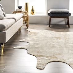 a living room filled with furniture and a white rug