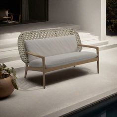 a white couch sitting next to a swimming pool