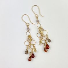 Whether they conjure whiskey or pumpkin spice for you, these lovely waterfall earrings exude all things fall and harvest!  2 1/2 inches of sparkling dangle! Briolette stones include Smokey Quartz and garnet, hand wrapped and hammered on gold-fill wires.  The metal is gold-fill, an heirloom quality metal consisting of 5% 14k gold over brass. Does not wear or chip off! Gold Leaf Jewelry, Oak Leaf Earrings, Waterfall Earrings, All Things Fall, Gold Lariat Necklace, Rectangle Earrings, Coin Pearls, Fall Earrings, Leaf Jewelry