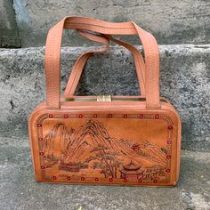 "Vintage 60s women bag, Tan leather bag, embossed handbag \"Chinese motif\", Retro style, a bag with handles Elegant vintage women bag \"Ballet\", light brown in color with two handles. Made in China in the 60s from genuine leather with an embossed image. This bag is from the times of Soviet-Chinese friendship. Retro style. Well preserved for its age. The latch works fine. The lining is whole. There is a slight dusting. In places slight scuffing of the skin. The bag is very roomy, comfortable, a Vintage Embossed Satchel For Everyday Use, Vintage Brown Embossed Shoulder Bag, Vintage Embossed Satchel Bag, Vintage Square Box Bag, Vintage Brown Embossed Satchel, Rectangular Embossed Satchel For Travel, Daily Use Rectangular Embossed Satchel, Vintage Embossed Shoulder Bag For Daily Use, Vintage Embossed Tote Bag