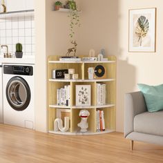 a living room with a washer and dryer next to a wall mounted shelf