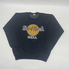 Vintage Hard Rock Cafe Seoul Korea Sweatshirt Size Large. Flaw threading coming undone at the sleeve cuffs see last picture for details. Measurements  Pit to pit 21" Length 24.5" IKU: 23.9.1.27 Vintage Long Sleeve Tops With Lettering, Vintage Long Sleeve Tops For Concert, Band Logo Long Sleeve Sweatshirt, Band Merch Sweatshirt With Long Sleeves, Vintage Long Sleeve Concert T-shirt, Vintage Long Sleeve T-shirt For Concerts, Casual Sweatshirt With Band Logo For Winter, Casual Fall Sweatshirt With Band Logo, Long Sleeve Cotton Tops With Band Logo