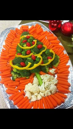 a platter with broccoli, cauliflower and carrots on it