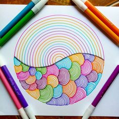 colored pencils and crayons on top of a paper with an image of a bowl