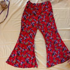 Red pants with a pretty floral print. HAS POCKETS! Flare leg bells. plus size 1x  Ready to ship with free shipping. Floral Print Flare Bottoms With Stretch, Stretch Red Floral Print Bottoms, Red Floral Print Bottoms For Spring, Red Floral Print Spring Bottoms, Spring Red Floral Print Bottoms, Bohemian Flare Pants With Floral Print, Red Bohemian Wide Leg Pants For Spring, Red Stretch Bohemian Pants, Bohemian Stretch Red Pants