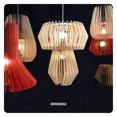 three lamps made out of book pages hanging from the ceiling in different shapes and sizes