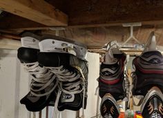 several pairs of ice skates are hanging from the ceiling