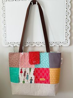 This is the perfect size for an everyday tote bag in popular Lori Holt cotton charm squares with cotton interior.  The inside features full width pocket with 3 sections and is very roomy. Bottom is linen fleeced for stability. 1" webbing is used on the straps which are 33" to wear over the shoulder. Includes a tab with magnetic snap to keep possessions safely inside.  This listing is for the tote bag only.  Care instructions:  This bag is made of 100% cotton and linen. I recommend spot cleaning Square Cotton Bags With Pockets, Everyday Patchwork Tote Shoulder Bag, Everyday Cotton Square Bag, Everyday Square Cotton Bag, Square Everyday Shoulder Bag, Everyday Square Cotton Bags, Everyday Square Fabric Shoulder Bag, Everyday Fabric Shoulder Bag With Patchwork, Square Fabric Shoulder Bag For Everyday