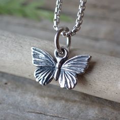 Crafted from sterling silver, this petite pendant measures a dainty 11mm in both width and height, capturing the exquisite details of a butterfly in flight.The butterfly represents profound transformation and the gentle reminder that beauty can emerge from change. Our Butterfly Charm Necklace celebrates the enduring elegance of this remarkable creature, serving as a wearable emblem of your own metamorphosis and the beauty of embracing life's transitions. Butterfly In Flight, Tiny Butterfly, Life Transitions, Old Jewelry, Recycled Silver, Butterfly Charm, In Flight, The Butterfly, Recycled Sterling Silver