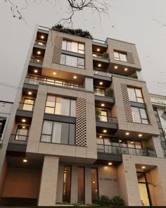 an apartment building with balconies and lights on