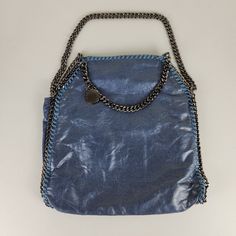 Stella Mccartney Tote Bag Womens Blue Falabella Metallic Shaggy Deer Curb Chain Trim. In Very Good Pre-Owned Condition. No Flaws Noted. - Metallic Faux Leather Shell - Chain Trim - Snap Closure - Metallic Fining - Made In Italy - Slouchy Style When Worn - Please Note: This Is A Heavyweight Bag Please Reference Photos For Approximate Dimensions Measurements Are Taken Laying Flat Please Send A Message With Any Questions You Have That Weren't Answered Within The Listing Trendy Blue Bag With Chain Detail, Blue Tote Shoulder Bag For Party, Blue Double Handle Shoulder Bag For Evening, Blue Double Handle Shoulder Bag For Party, Blue Party Shoulder Bag With Double Handle, Blue Tote Shoulder Bag With Chain Strap, Blue Rectangular Bag With Chain Strap, Blue Top Handle Shoulder Bag With Chain Strap, Rectangular Blue Bag With Chain Strap