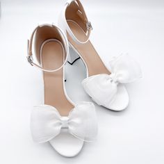 "These Classic Bow Shoe Clips can be worn on the front, back or side of most heels. Listing is for one pair. Shoes not included. *Bows need to be fluffed upon arrival. *Bows can not be worn side by side because they are too wide. - 1 pair - 5\" wide - Made in the USA SHOP MORE SHOE CLIPS, https://www.etsy.com/shop/melissavelia?section_id=24145024 *Although clips are gentle and cushioned, each shoe fabric is different. Please test out the clips on your shoes before leaving them on for a long period of time. We are not responsible for any indentation." White Sandals With 4-inch Heel For Prom, Closed Toe Heels For Summer Bridal Shower, Closed Toe Heels For Bridal Shower In Summer, Summer Bridal Shower Closed Toe Heels, White Heels With Bow And Open Heel, White Sandals With Bow And Open Heel, White Open Heel Heels With Bow, White Open Heel Sandals With Bow, White Sandals For Prom In Spring