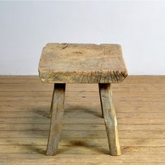 a wooden stool sitting on top of a wooden floor