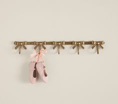 a pair of ballet shoes hanging on a wall