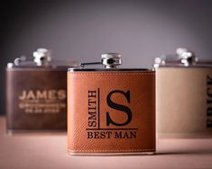 three leather flasks with the name smith's best man on them