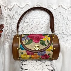 ✨Details: vintage 60s colorful floral raffia straw barrel style bag with wooden ends. Features gold metal turn clasp closure and hardware.  Brand: Bags by Whidby ✨Sizing: Body of purse measures approximately 10.25" wide and 6.5" tall. Total height including handle is 14".  ✨Condition: Great vintage condition with no major defects overall; has a couple minor imperfections such as small scratches on wood end and one of the gold studs is missing from the back (not very noticeable) See last photo for close ups Vintage Natural Bucket Shoulder Bag, Vintage Straw Bag For Daily Use, Vintage Satchel Bag With Bamboo Handle, Vintage Brown Satchel Straw Bag, Handmade Vintage Straw Bag, Vintage Summer Straw Satchel Bag, Vintage Summer Satchel Straw Bag, Vintage Straw Travel Bag, Vintage Natural Straw Bag