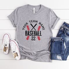 a t - shirt that says your team name baseball 22 and two bats on it