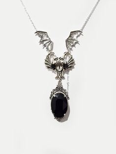 ◆ Silver plated gothic necklace with bat and black crystal. The crystal measures 0,984252 x 0,708661 inches and is very bright, the jewel is embellished with a cameo with Victorian decorations. All necklaces in my shop are adjustable in length, but if you have demanding details you can safely contact me! ❤ The product is handmade with great care. ♡ In my shop there are many handmade jewelry for sale for all tastes, come and look at them you are welcome! ♡ ❤ Do you need a custom order? ❤ You can enter a free note to send together with your purchase, or you can contact me if you need any information. ✮ How will your jewelry be packaged? ✮ All my jewelry are sent together with a card, in a clear cellophane package and placed in an elegant free black organza gift bag. If you need a gift box wi Gothic Pendant Necklace For Halloween, Halloween Gothic Pendant Jewelry, Halloween Gothic Pendant Necklace, Black Vampire Pendant Jewelry, Black Vampire Style Pendant Jewelry, Gothic Metal Necklaces With Jewels, Gothic Metal Necklace, Elegant Halloween Pendant Necklace, Gothic Pendant Necklace With Jewels