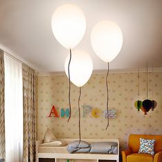 a child's bedroom with three lights hanging from the ceiling