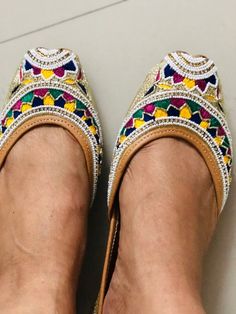 'WHITE BEADED' is an extraordinary jutti intricately hand embroidered by our finest artisans.Silk base with white beads, multi colored embroidered in white pearls, small swarovski beads and gold dabka strings in the front and on the back. Like its name, it's elegant, timeless and graceful!PERFECT FOR ANY OCCASION AND ANY OUTFIT!!*Ethnic Shoes/Women Flats/Handmade Indian Designer Women Shoes or Slippers/Royal shoes/traditional style Women/Wedding Shoes/Bridal ShoesSPECIFICATIONS:•Upper/Panna -Fab Multicolor Flat Shoes For Festive Occasions, Bollywood Style Embroidered Flats For Navratri, Traditional Multicolor Flats For Festivals, Traditional Multicolor Flats For Festive Occasions, Festive Multicolor Flats With Gota Work, Festive Multicolor Gota Work Flats, Embroidered Multicolor Flats With Round Toe, Multicolor Slip-on Flats With Gota Work, Embroidered Multicolor Round Toe Flats