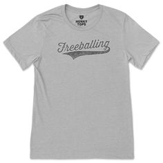 Celebrate the freedom of comfort with our Freeballing Comfort Tee. It's a playful homage to those days when you want to keep things breezy and carefree. This tee is designed for the man who enjoys a relaxed fit and a humorous twist to his everyday wear. Emblazoned with the word "Freeballing" in a sporty, vintage font, this shirt doesn't shy away from a bit of cheeky confidence. It's perfect for a laid-back weekend, a casual meet-up with friends, or any time you want to embrace the liberating feeling of going commando, in spirit or in practice. Crafted for comfort and styled with a wink, it's more than just a t-shirt—it's a lifestyle statement. Pull on this shirt and step out in airy, unconstrained style that says you're the kind of guy who plays by his own rules. Sports T-shirt With Lettering And Short Sleeves, Going Commando, Vintage Font, Vintage Fonts, Raglan Shirts, Tank Shirt, Tank Top Shirt, Everyday Wear, Relaxed Fit