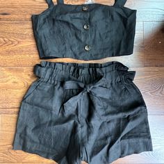 New Never Worn. Black Two Piece Set With Paper Bag, Tie Waist Shorts And Top. Straps Have Two Button Adjustment And Buttons In Front Are Functional. Size Medium. Black Bottoms With Buttons For Summer, Black Buttoned Bottoms For Summer, Black Shorts With Buttons For Spring, Chic Black Shorts With Buttons, Black Button Closure Shorts For Summer, Summer Black Bottoms With Button Closure, Black Casual Shorts For Going Out, Casual Black Shorts For Going Out, Black Two Piece Set