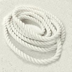 a white rope is laying on the ground