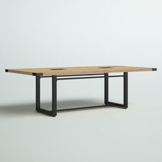 a wooden table with black metal legs and a square top on an isolated white background